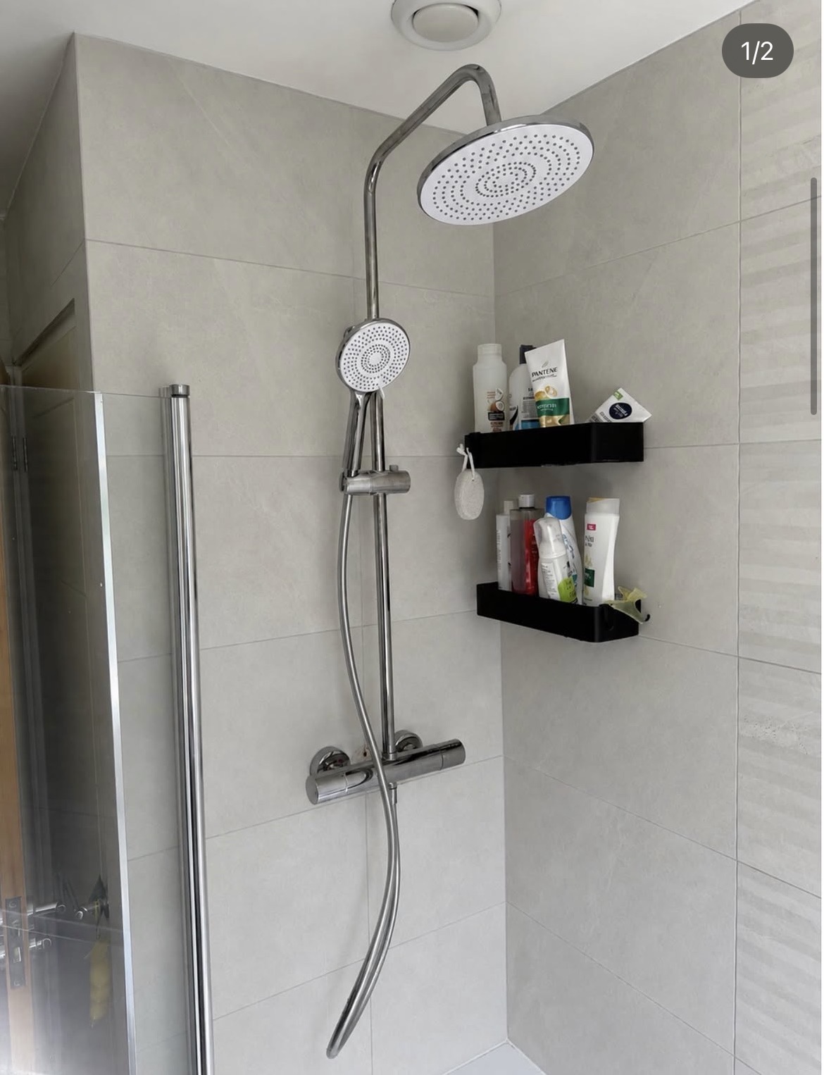 Completed grey tiled shower enclosure with rainfall shower