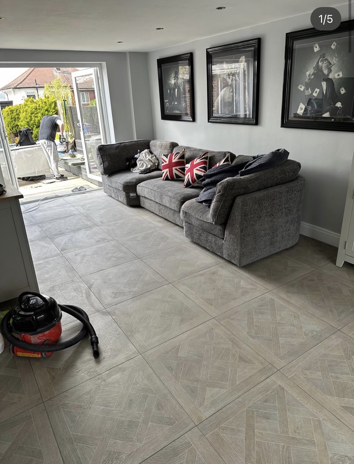 Completed patterned grey floor tiling across an open-plan living space