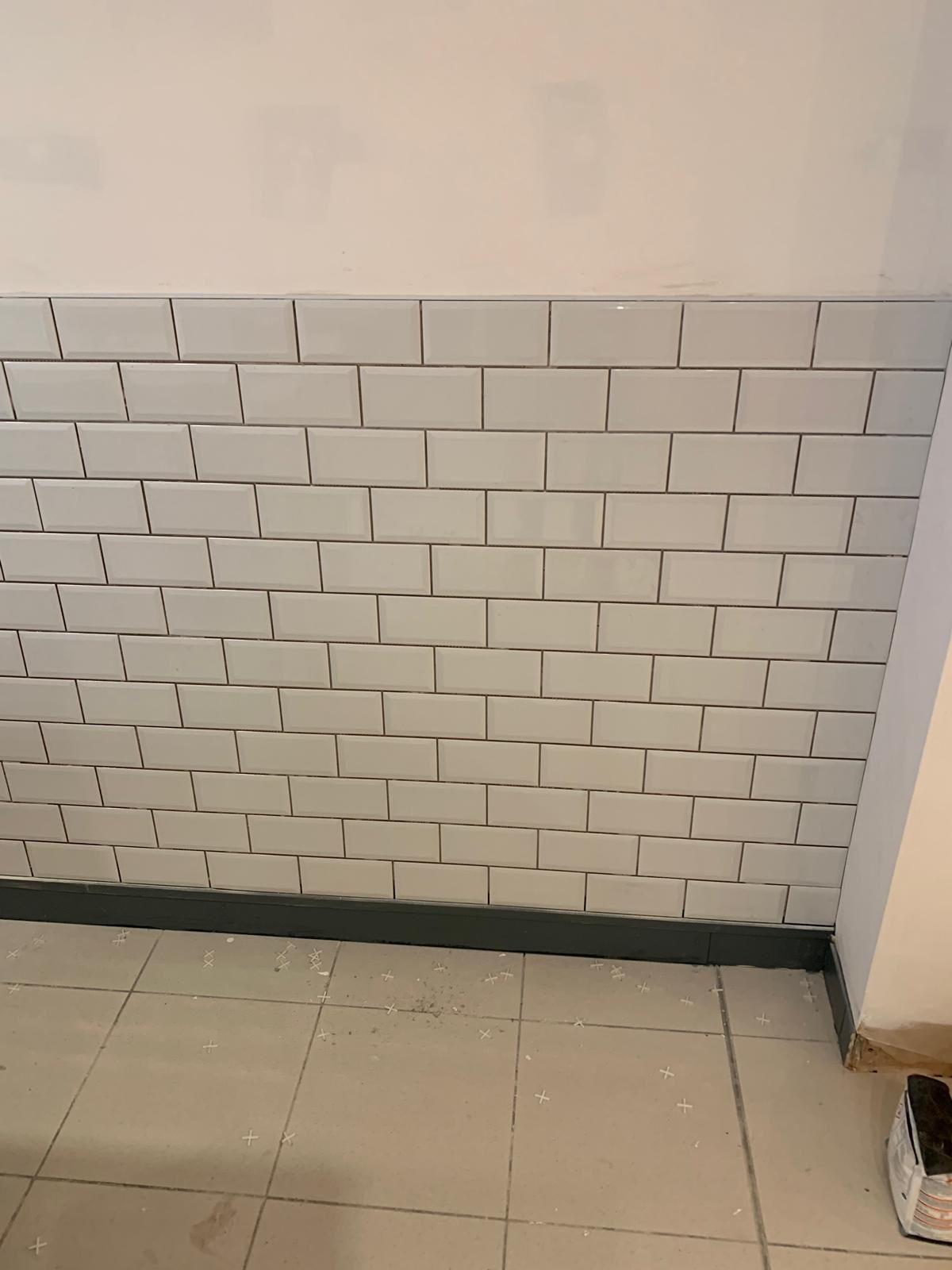 White metro tile splashback with contrasting dark grout
