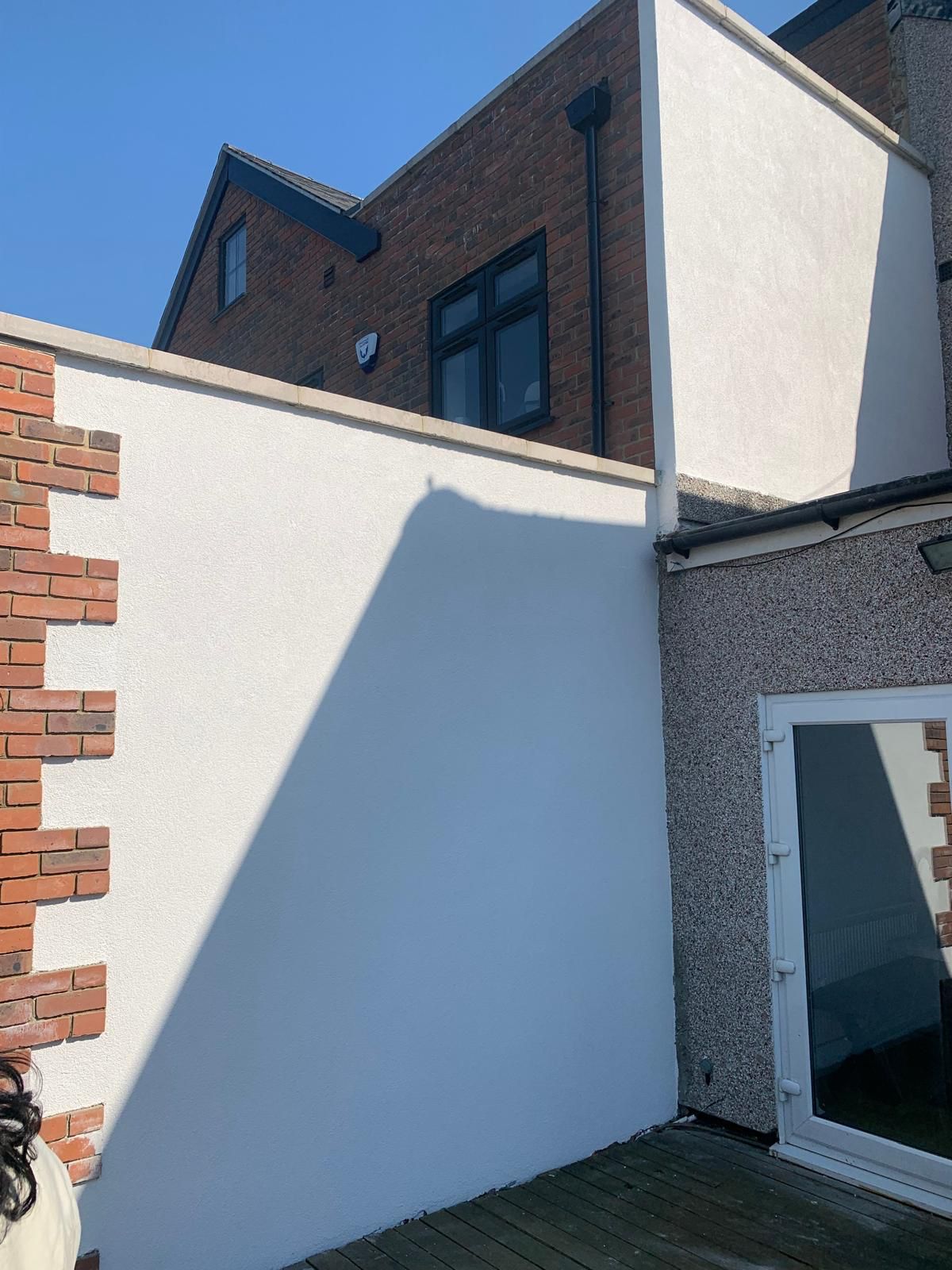 Completed white render to a residential extension wall