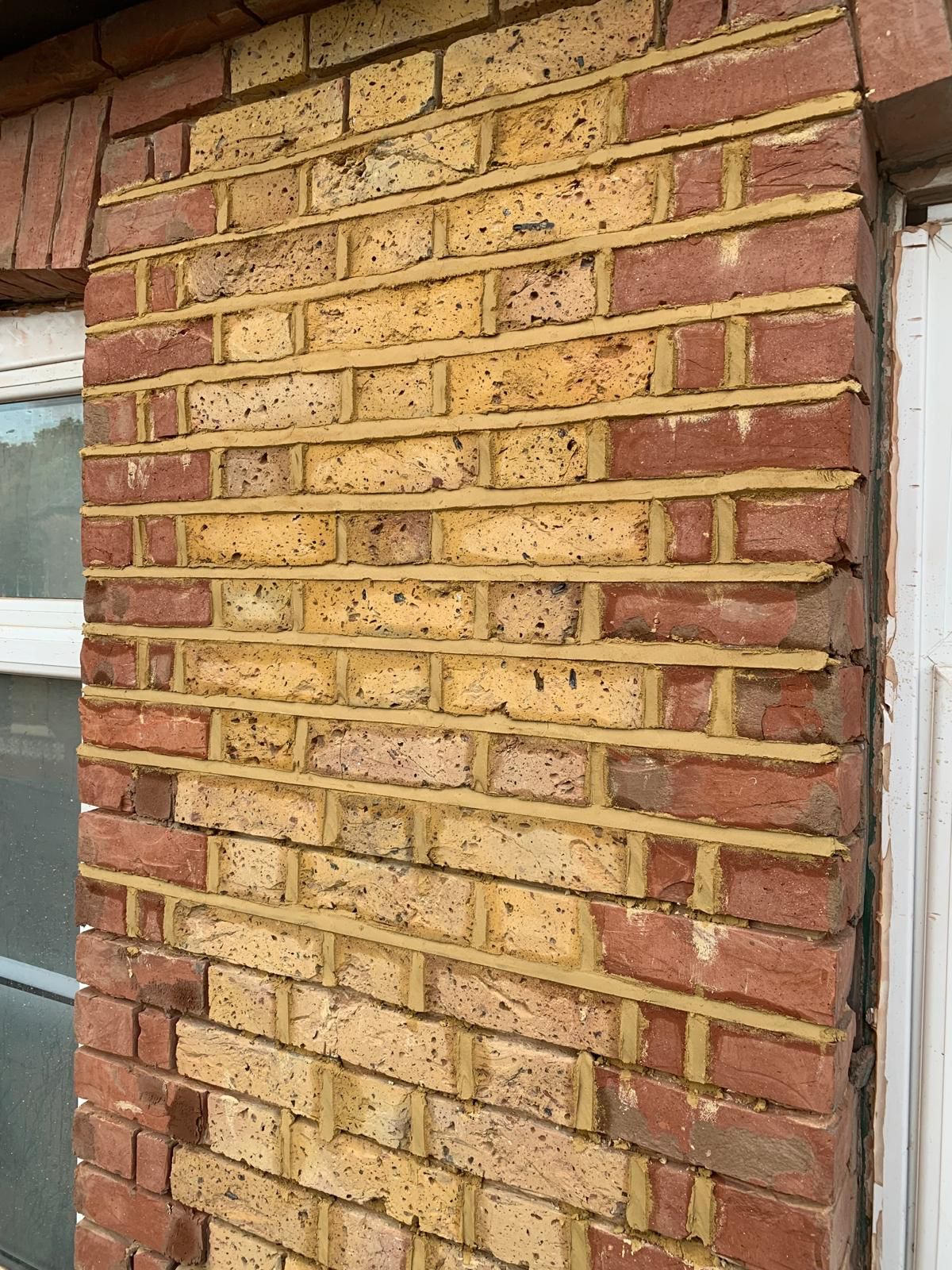 Completed brickwork repairs and repointing to an external wall